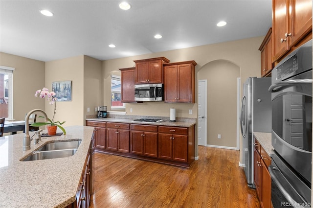 16685 E 101st Ave, Commerce City, CO 80022 - kitchen with stainless steel appliances, arched walkways, a healthy amount of sunlight, and a sink