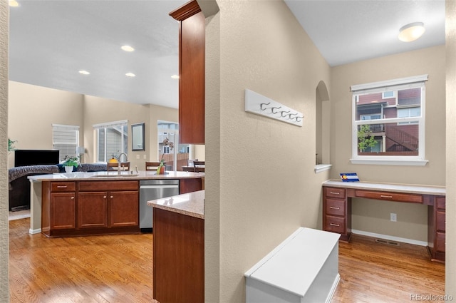 16685 E 101st Ave, Commerce City, CO 80022 - kitchen with a sink, arched walkways, light wood-style flooring, and dishwasher