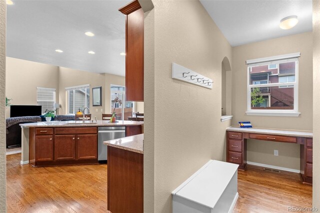 16685 E 101st Ave, Commerce City, CO 80022 - kitchen with a sink, arched walkways, light wood-style flooring, and dishwasher