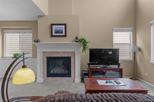 16685 E 101st Ave, Commerce City, CO 80022 - living room featuring baseboards, carpet flooring, and a fireplace