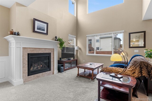16685 E 101st Ave, Commerce City, CO 80022 - carpeted living room with a high ceiling and a tile fireplace
