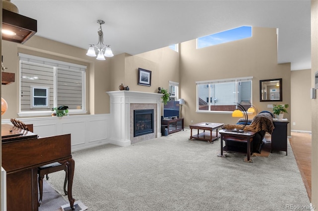 16685 E 101st Ave, Commerce City, CO 80022 - living room featuring an inviting chandelier, a high ceiling, carpet, and a tile fireplace