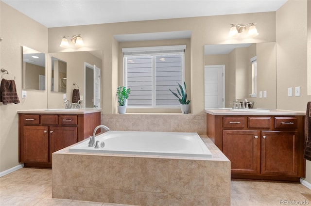 16685 E 101st Ave, Commerce City, CO 80022 - bathroom featuring a sink, a garden tub, and two vanities