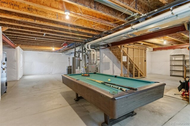 16685 E 101st Ave, Commerce City, CO 80022 - recreation room featuring concrete flooring, heating unit, billiards, and gas water heater