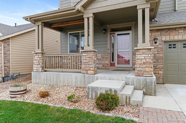 16685 E 101st Ave, Commerce City, CO 80022 - doorway to property with covered porch, driveway, a shingled roof, and stone siding