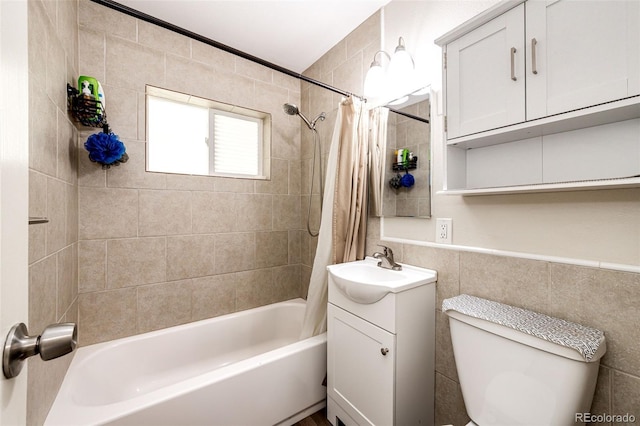 1183 S Umatilla St, Denver, CO 80223 - full bathroom with vanity, shower / bathtub combination with curtain, toilet, and tile walls