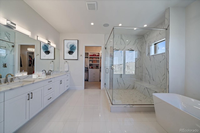 5254 Creation Rock Trl, Morrison, CO 80465 - full bathroom featuring a sink, a walk in closet, a marble finish shower, and visible vents