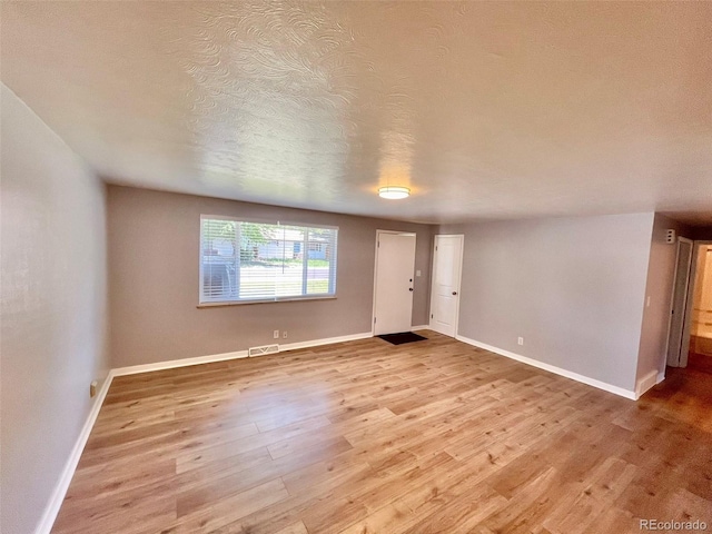 9600 W 18th Dr Unit 9610, Lakewood, CO 80215 - unfurnished living room with wood finished floors and a textured ceiling
