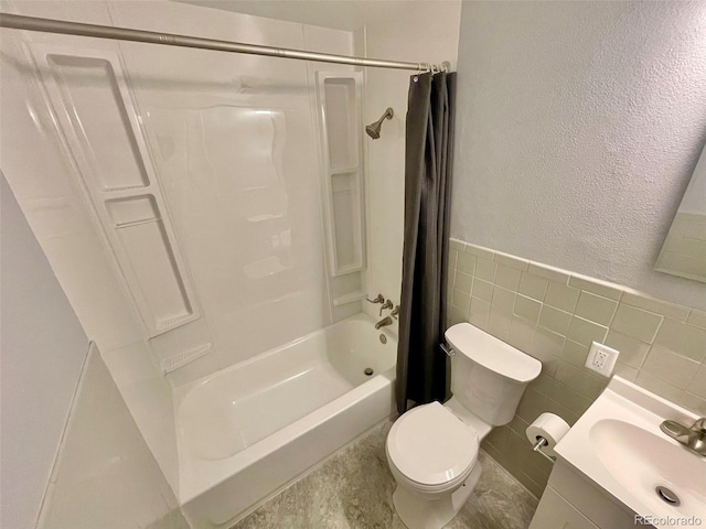 9600 W 18th Dr Unit 9610, Lakewood, CO 80215 - bathroom featuring shower / tub combo, vanity, a textured wall, wainscoting, and tile walls