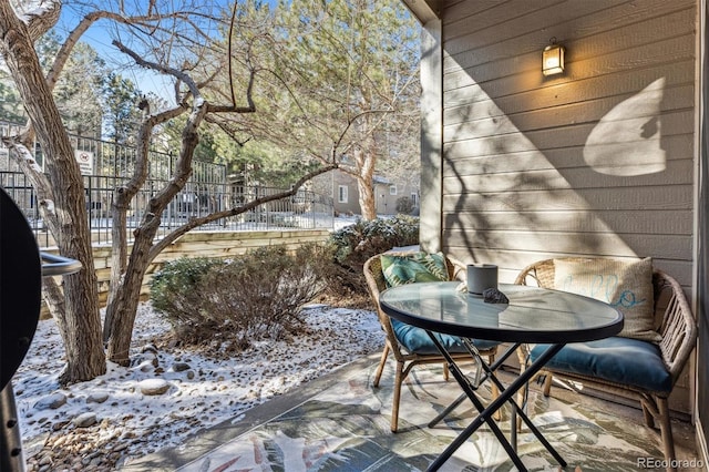 view of snow covered back of property