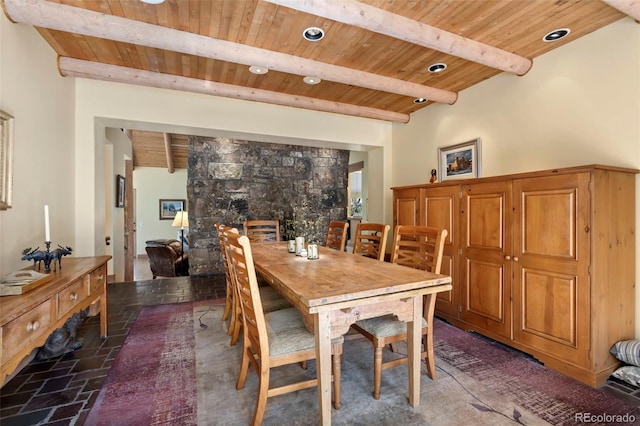 2611 Fox Acres Dr E, Red Feather Lakes, CO 80545 - dining area featuring wooden ceiling with exposed beams, stone tile flooring, and a fireplace