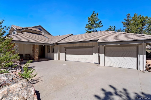 2611 Fox Acres Dr E, Red Feather Lakes, CO 80545 - single story home with driveway, an attached garage, a tile roof, and board and batten siding