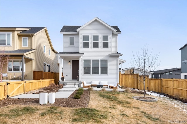 view of front of house with a front yard and a patio