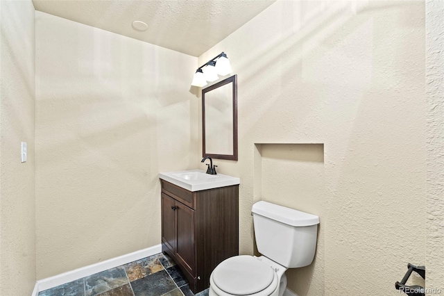 9432 La Quinta Way, Lone Tree, CO 80124 - bathroom with vanity, toilet, stone finish flooring, and baseboards