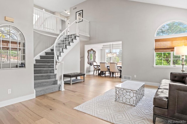 9432 La Quinta Way, Lone Tree, CO 80124 - living area with a towering ceiling, stairs, and wood finished floors