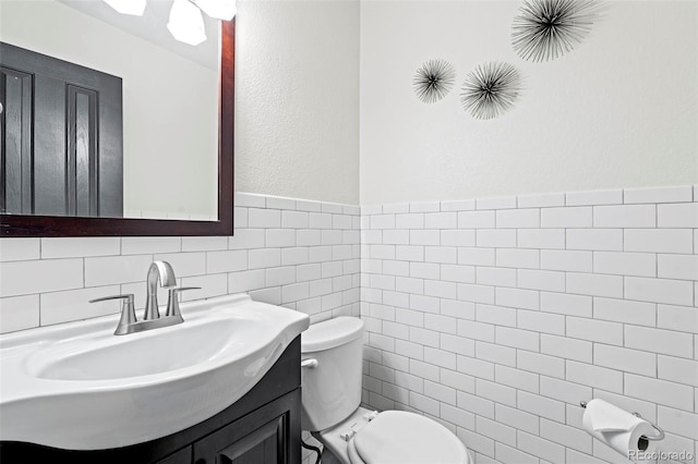 9432 La Quinta Way, Lone Tree, CO 80124 - half bathroom with tile walls, vanity, and a wainscoted wall