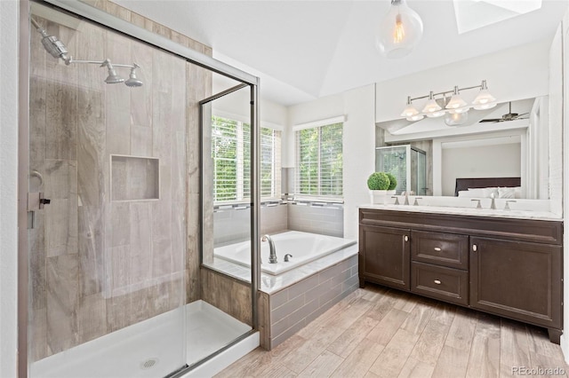 9432 La Quinta Way, Lone Tree, CO 80124 - bathroom with a bath, a stall shower, vanity, a skylight, and wood finished floors