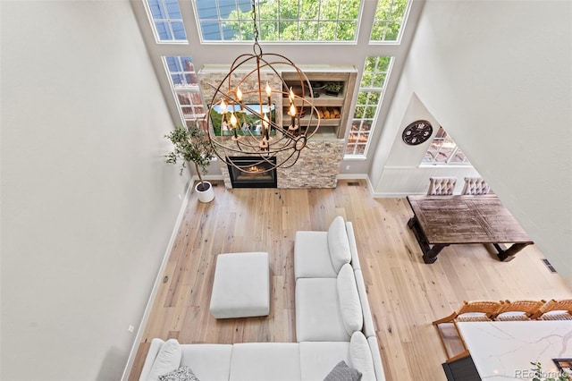 9432 La Quinta Way, Lone Tree, CO 80124 - living room featuring a chandelier, wood finished floors, healthy amount of natural light, and a towering ceiling