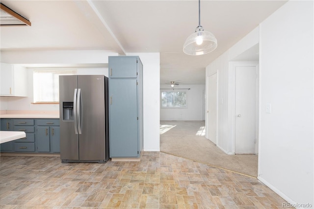 kitchen with stainless steel fridge, light colored carpet, hanging light fixtures, and ceiling fan