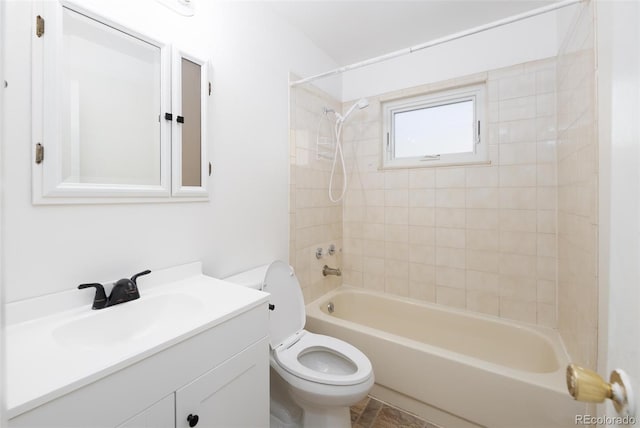 full bathroom with toilet, vanity, and tiled shower / bath