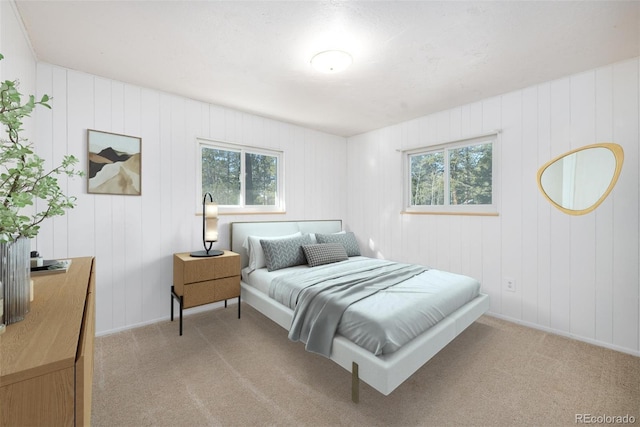 carpeted bedroom featuring multiple windows