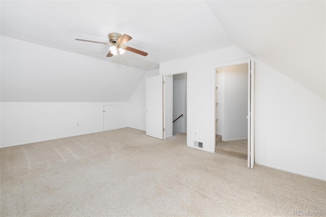 bonus room featuring ceiling fan, light colored carpet, and vaulted ceiling