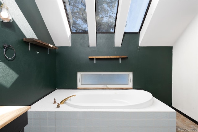 bathroom with a relaxing tiled tub