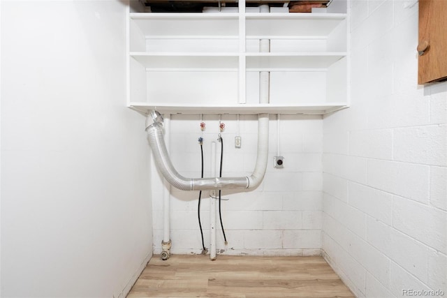 laundry room featuring washer hookup, light hardwood / wood-style flooring, and electric dryer hookup