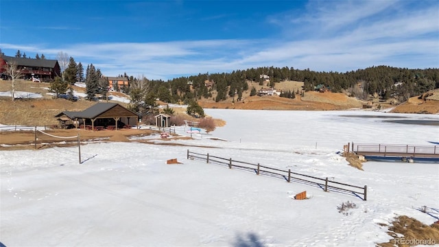 yard covered in snow featuring a rural view