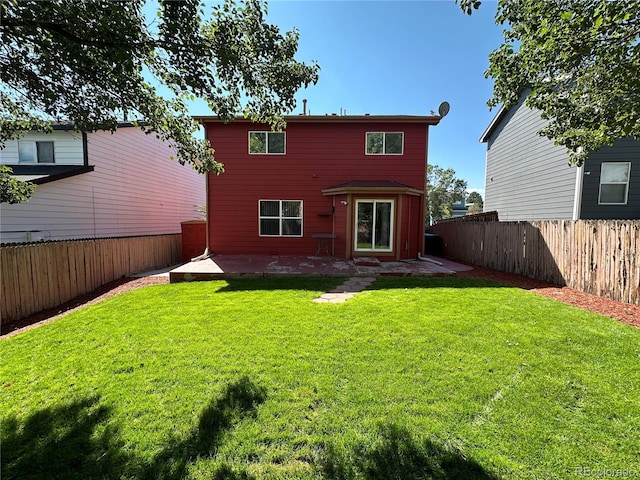 back of house with a yard and a patio area