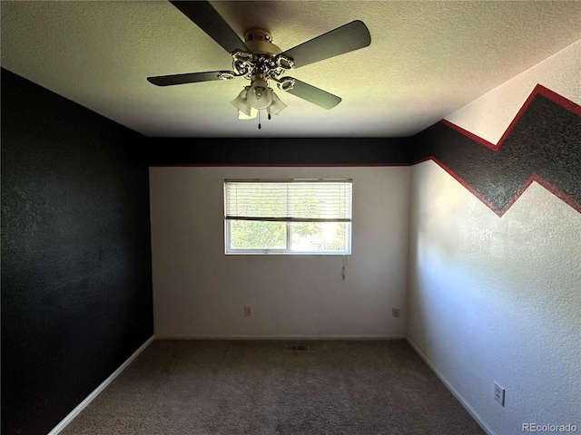 unfurnished room with a textured ceiling, carpet flooring, and ceiling fan