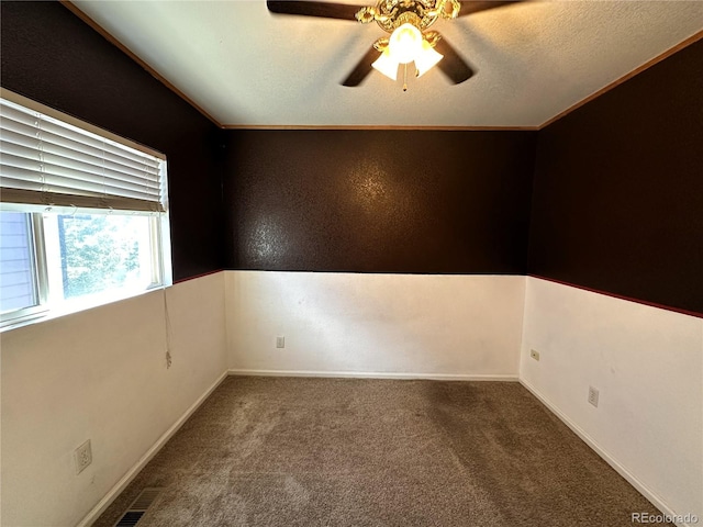 spare room featuring ceiling fan, carpet floors, and ornamental molding