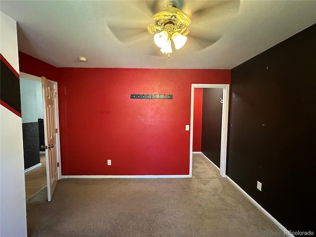 unfurnished bedroom featuring ceiling fan, carpet floors, and a textured ceiling