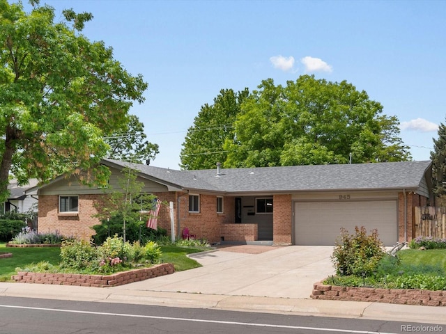 945 Emerald St, Broomfield, CO 80020 - ranch-style home featuring brick siding, an attached garage, and concrete driveway