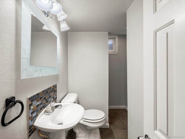 945 Emerald St, Broomfield, CO 80020 - bathroom with toilet, tile patterned floors, and a sink