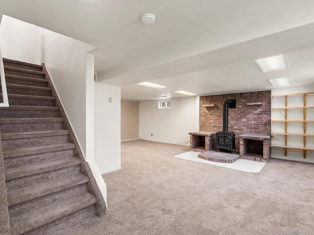 945 Emerald St, Broomfield, CO 80020 - finished basement featuring a wood stove, carpet, stairway, and baseboards