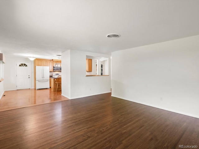 945 Emerald St, Broomfield, CO 80020 - unfurnished living room featuring dark wood-style floors and baseboards