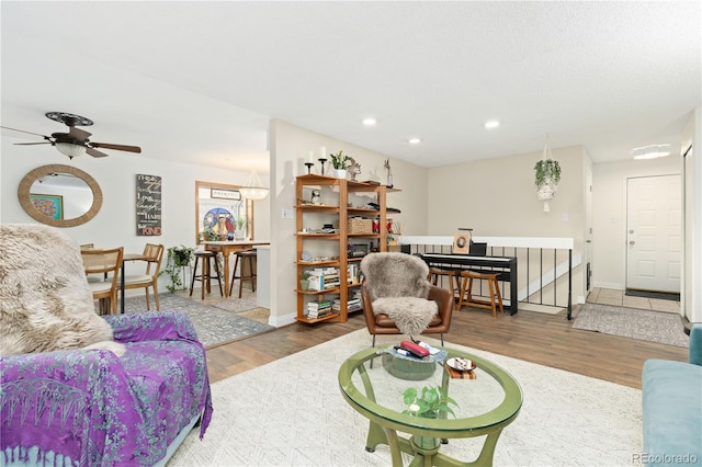 living room featuring ceiling fan and wood-type flooring