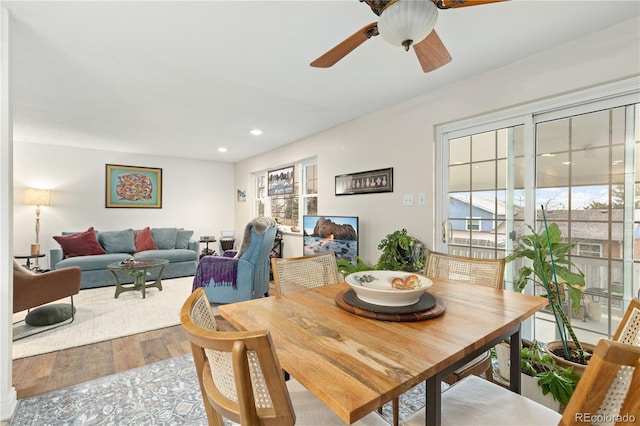 dining room featuring ceiling fan, a healthy amount of sunlight, and hardwood / wood-style flooring