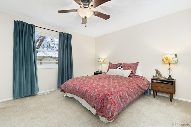 bedroom featuring light carpet and ceiling fan