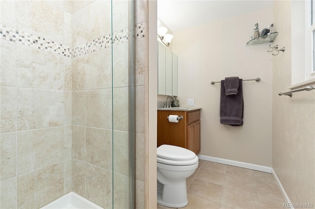 bathroom with a tile shower, vanity, and toilet