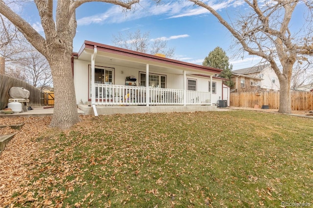 ranch-style home featuring central air condition unit, a porch, and a front yard