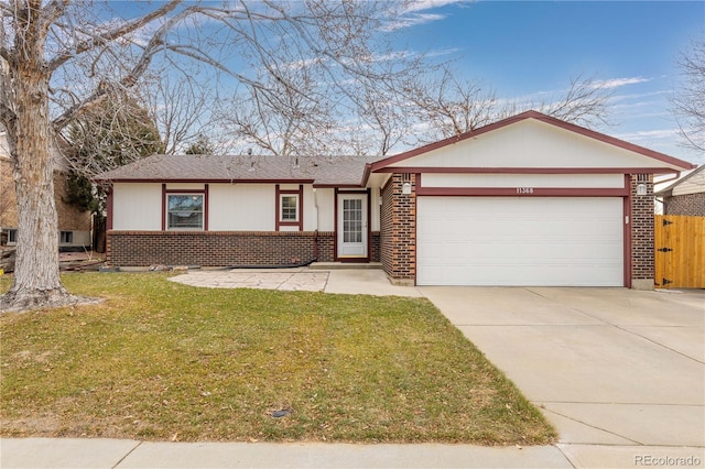 single story home featuring a garage and a front yard