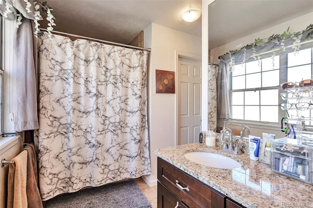 full bathroom with vanity and curtained shower