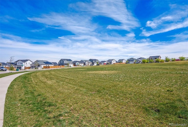 view of home's community with a residential view and a lawn