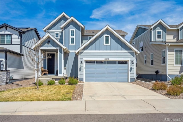 craftsman house with board and batten siding, a garage, concrete driveway, and a front lawn