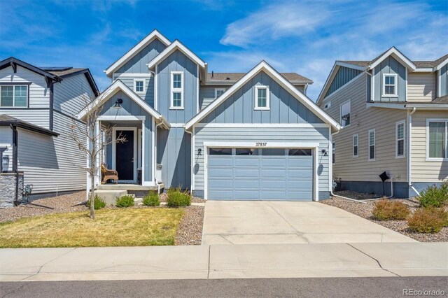 27837 E 8th Ave, Aurora, CO 80018 - craftsman house with board and batten siding, a garage, concrete driveway, and a front lawn