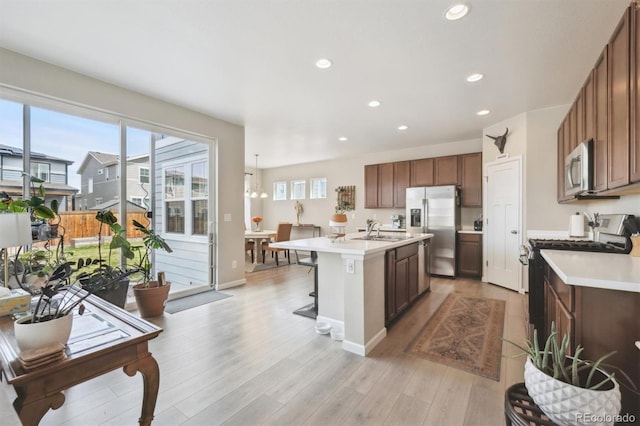 kitchen with light countertops, stainless steel appliances, a healthy amount of sunlight, and a sink
