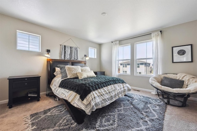 bedroom with carpet floors and baseboards
