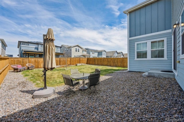 view of yard featuring a fenced backyard and a residential view